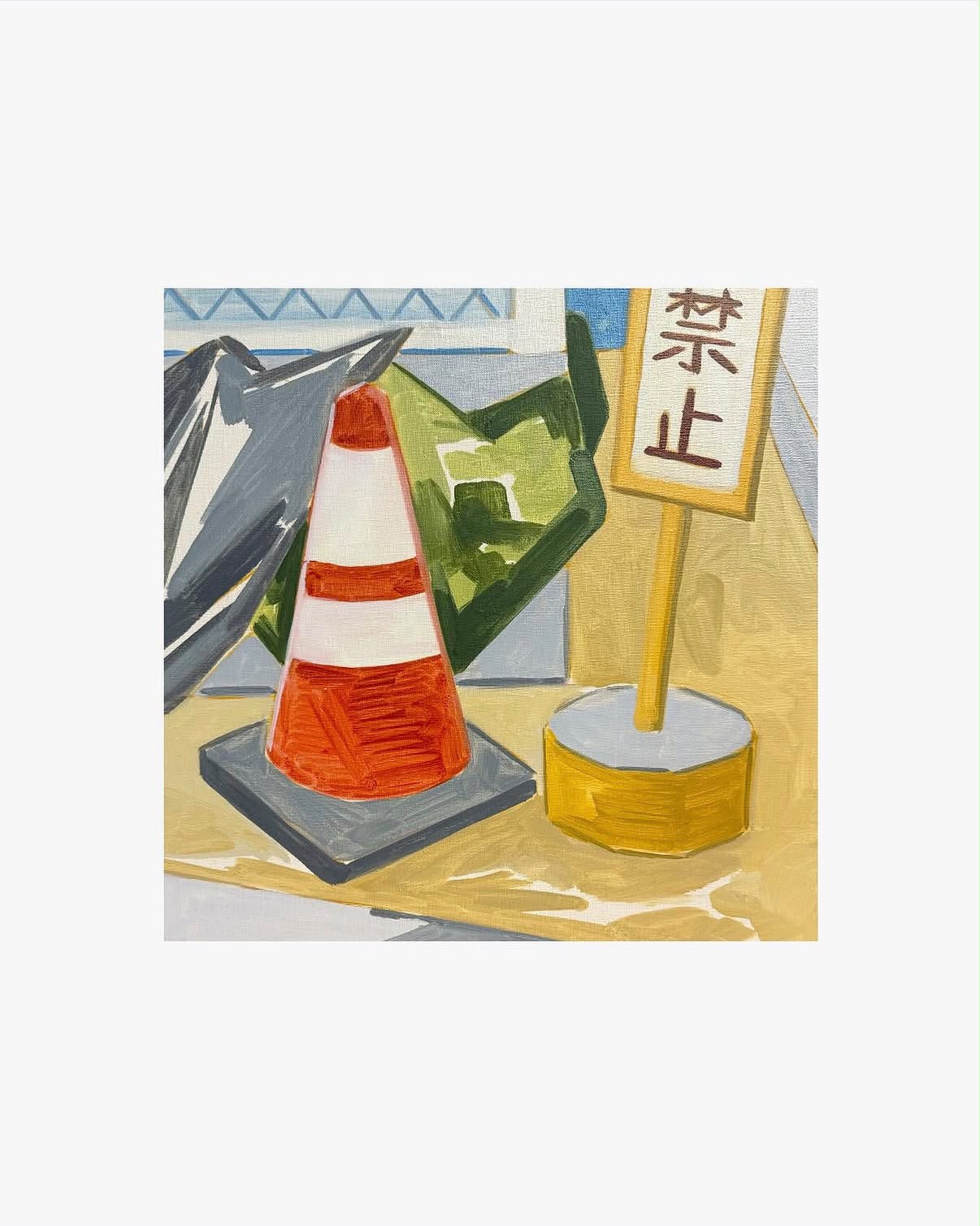 A painted street corner with a traffic cone and Japanese sign
