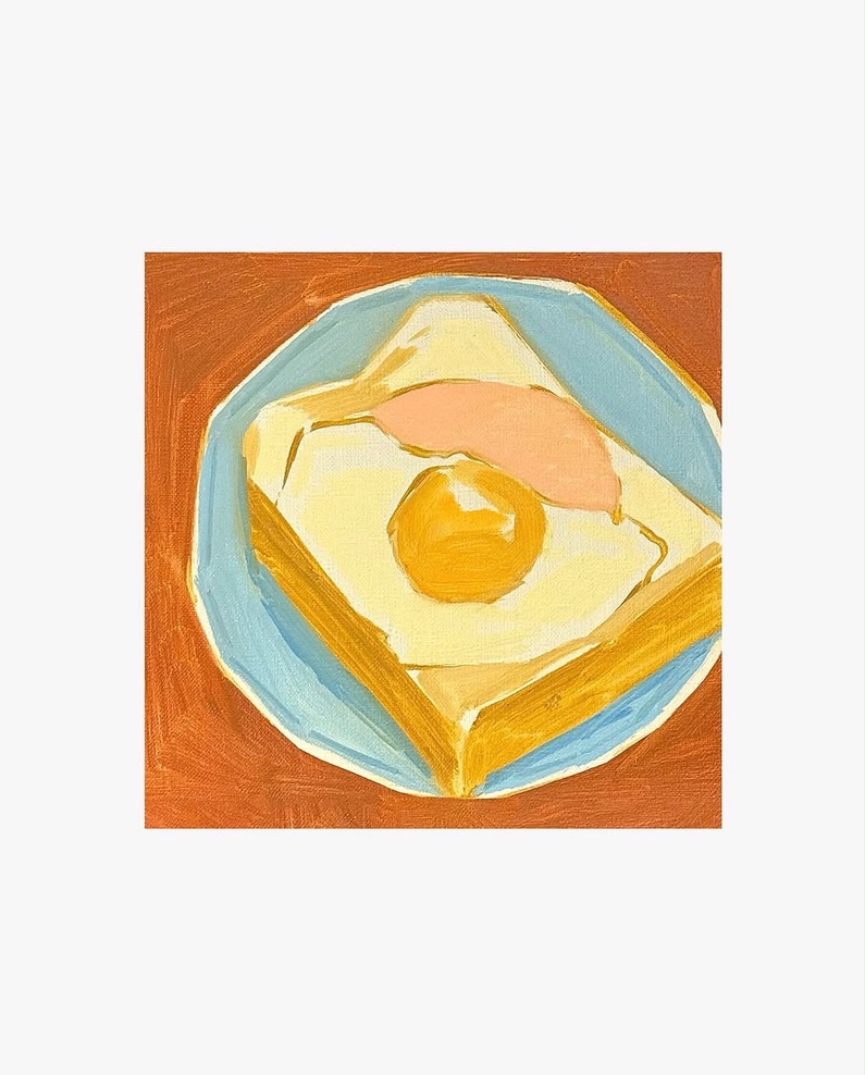 A fried egg on toast in a blue dish
