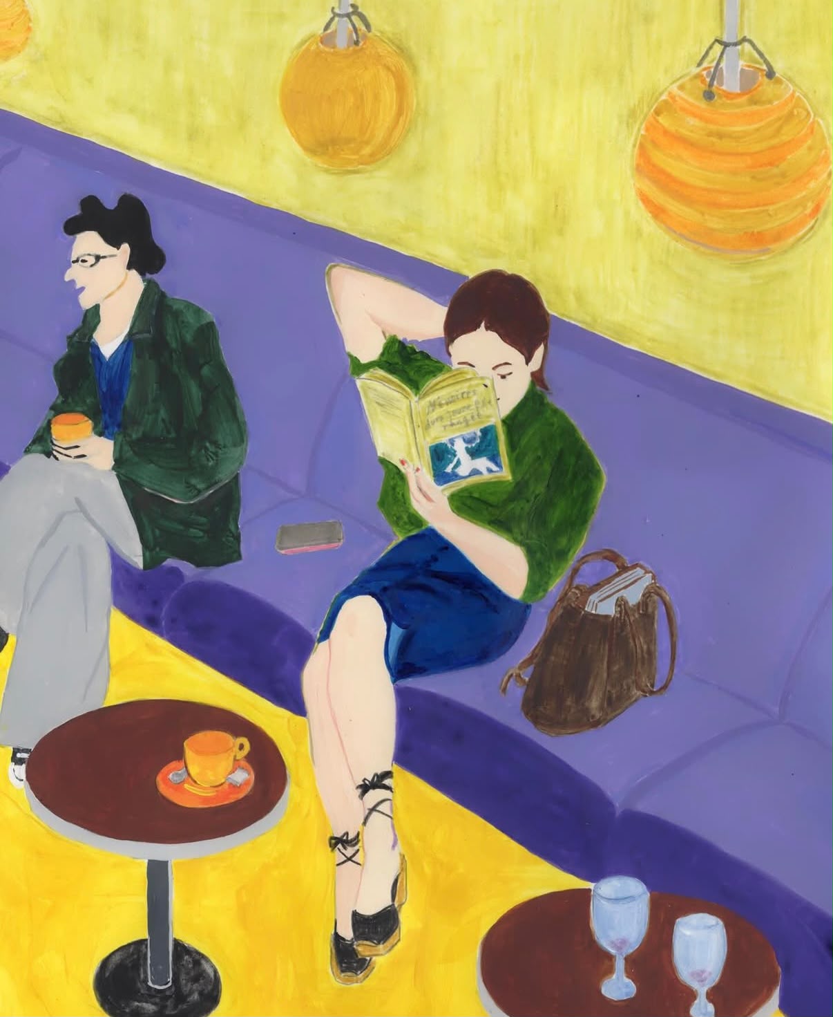 Two people reading and talking in a colourful café